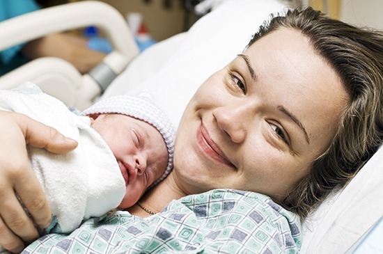 a mom and her baby smiling
